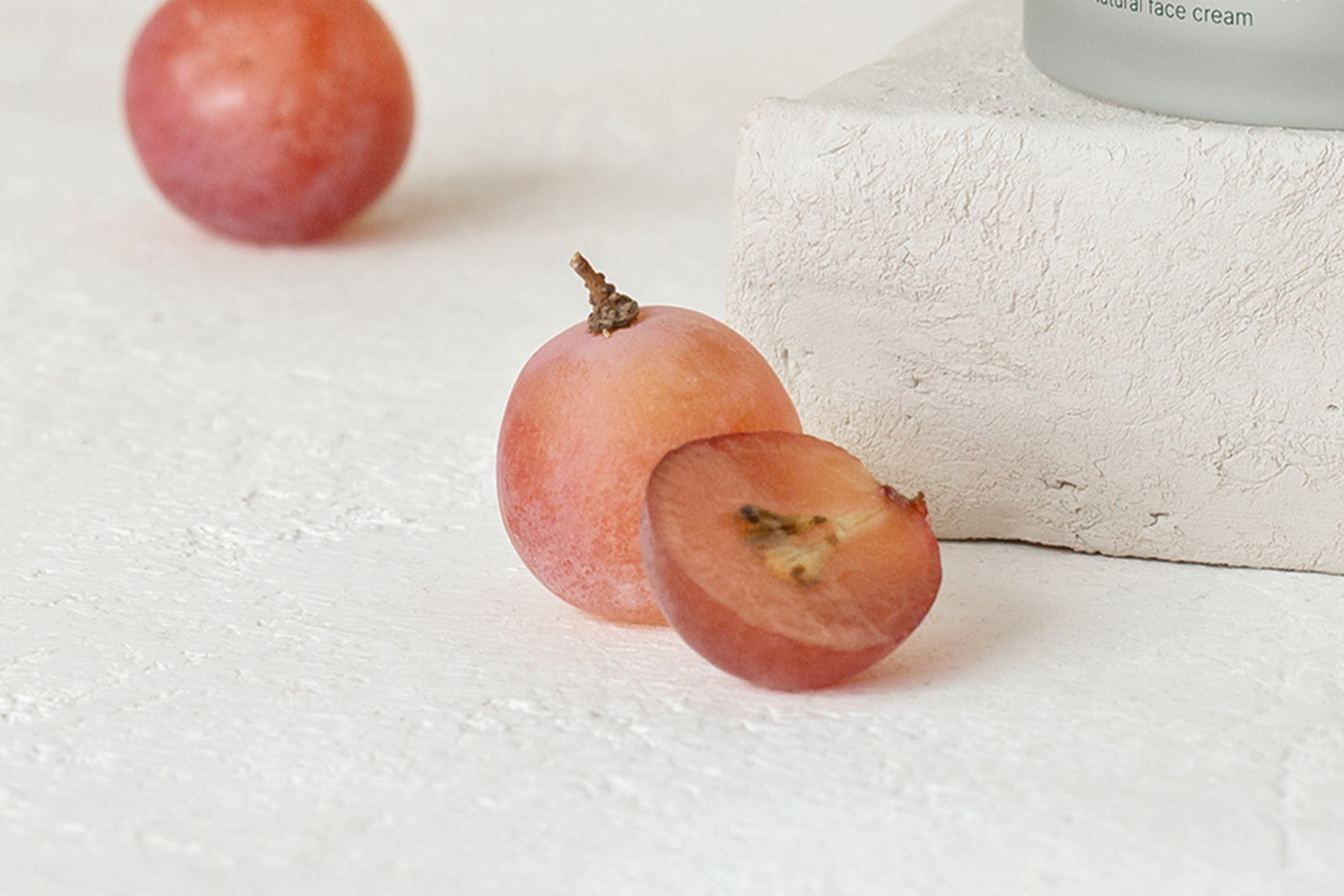 red globe grape with seed on clay surface