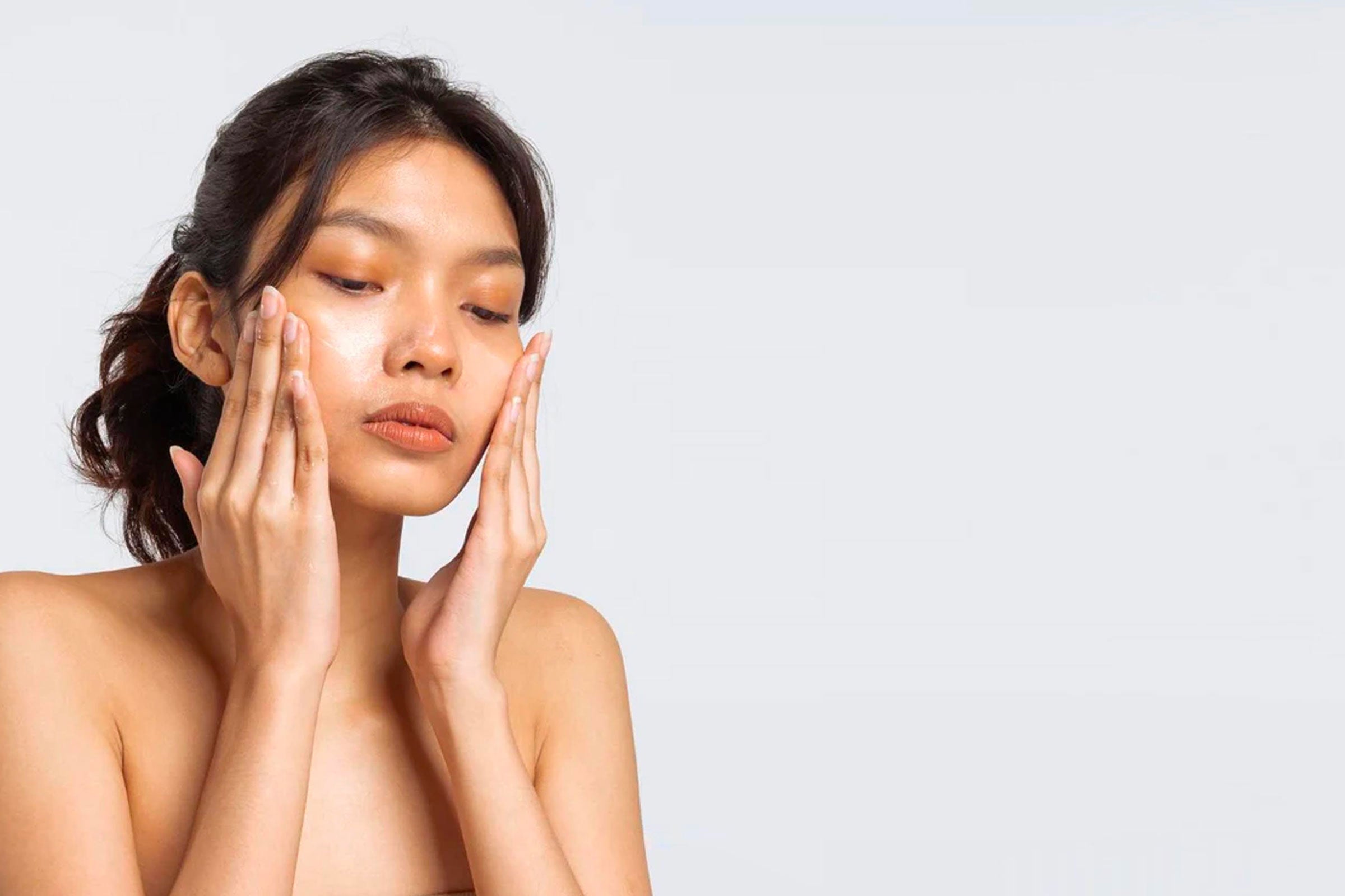 woman takes care of her skin with Grapey cream